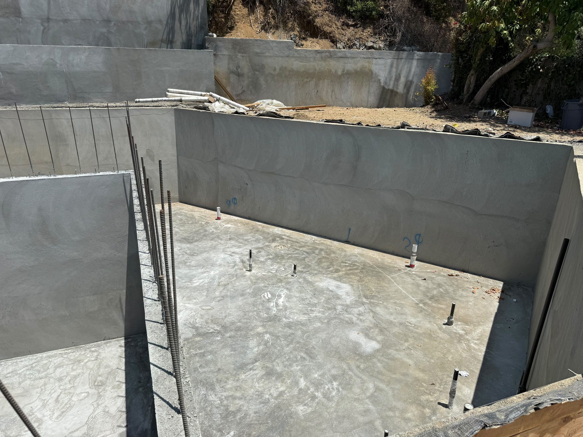 Interior view of a poured concrete foundation with access ladder