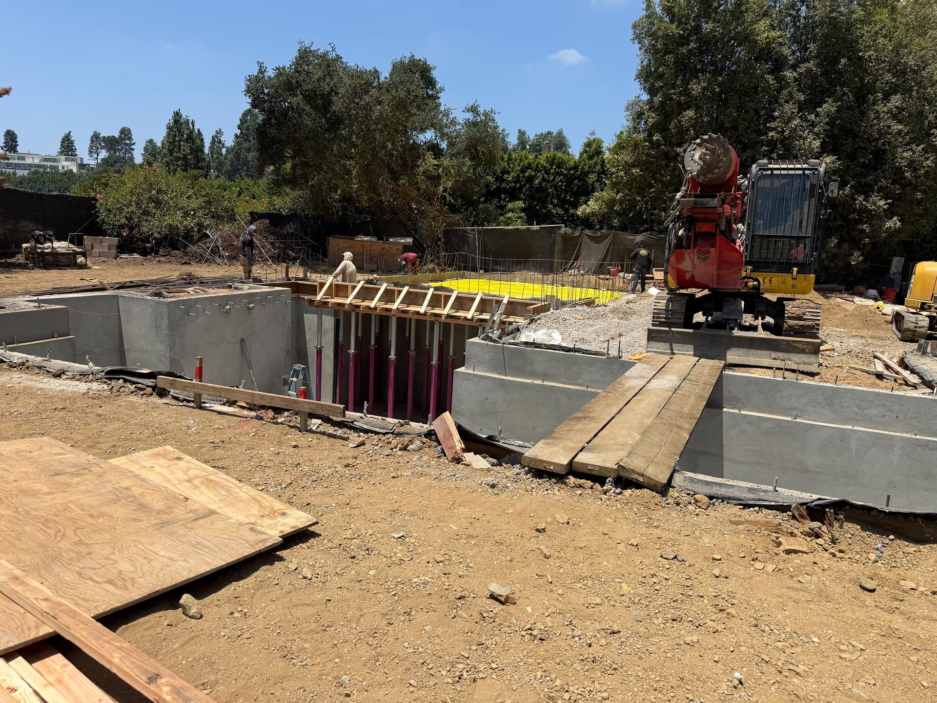 Concrete pump truck pouring a foundation on an active job site