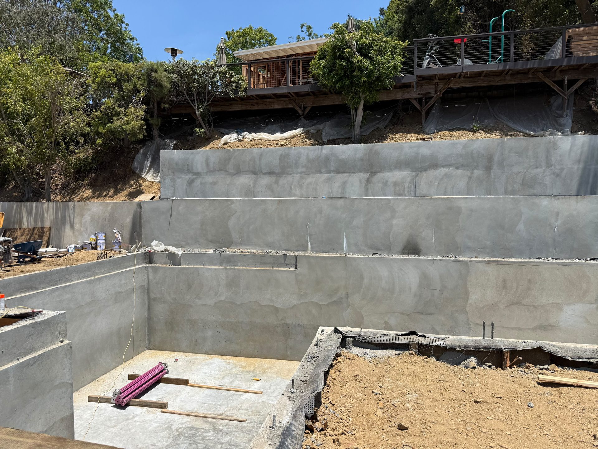 Large board formed concrete retaining wall and building pad on a California hillside