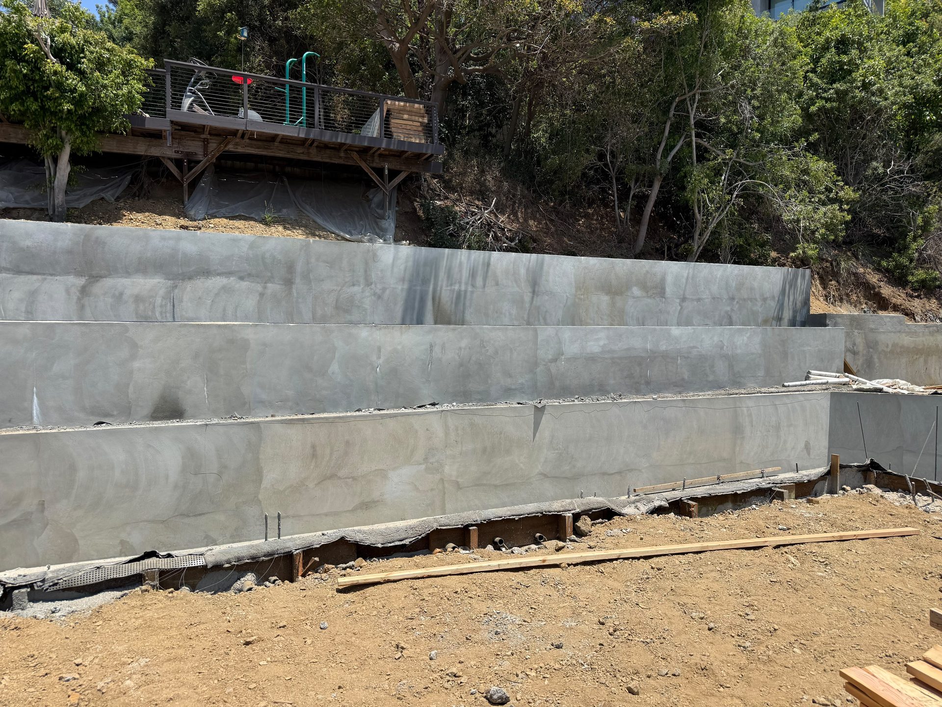 Tiered board formed concrete retaining walls on a hillside lot